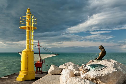 The pier in Senigallia at sunset after a storm.