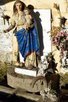 Virgin Mary and Child Jesus over an old water fountain with a laundry tub