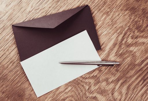 envelope with blank and pen on the wooden table