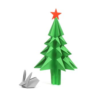 Green origami christmas tree and rabbit isolated on white background