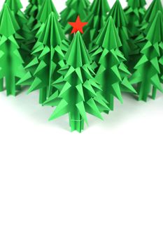 Green origami christmas trees isolated on white background
