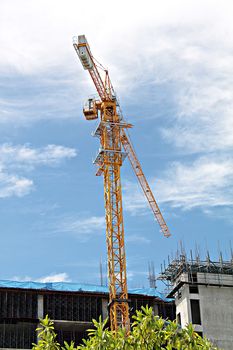 Construction site with crane and building on sky background, construction of the new building, construction crane