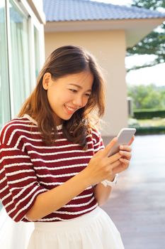 portrait of beautiful young woman reading message in smart phone use for modern people digtal life in connecting technology