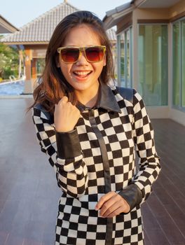 portrait of beautiful teen girl wearing sun glasses with lovely acting toothy smiling happy emotion 