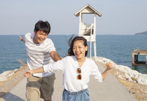 young man and pretty woman joyful emotion and playing at sea side vacation and relaxing time 