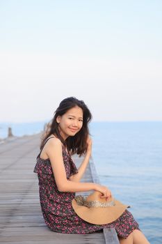 portrait of beautiful woman wearing long dress and straw hat looking to camera use for people vacation in paradise destination