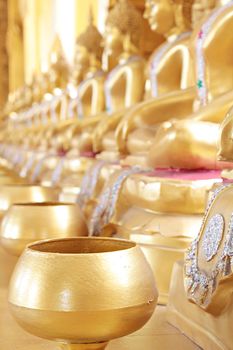 Golden monk's alms bowl and golden buddha statue at Paknam Jolo Temple, Bangkhla, Thailand