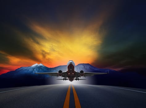 jet plane flying over runways against rock mountain and beautiful dusky sky with copy space use for air transport ,journey and traveling industry business 