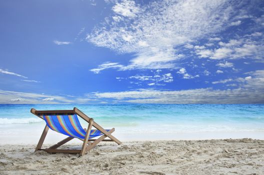 wood chairs deck on white sand beach with clear blue sea water and cloudy sky use for natural haliday vacation destination