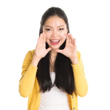 Portrait of Asian female, shouting and looking at camera, standing isolated on white background.