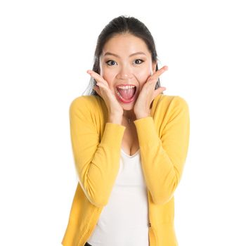 Shocked Asian woman mouth open wide, shouting and looking at camera, standing isolated on white background.