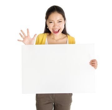 Portrait of surprised Asian girl hand holding blank white paper card and smiling excitedly, isolated on white background.