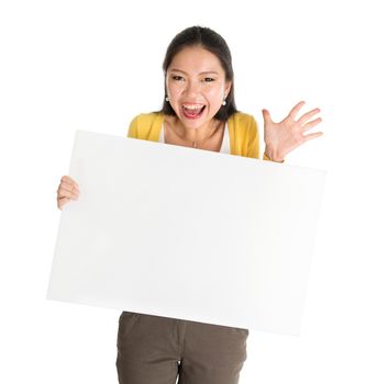 Portrait of surprised Asian girl hand holding blank white paper card and smiling excitedly, isolated on white background.