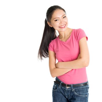 Portrait of happy young Asian woman in pink shirt and jeans with ponytail hair, standing isolated on white background.
