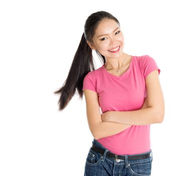 Portrait of happy young Asian girl in pink shirt and jeans with ponytail hair, standing isolated on white background.