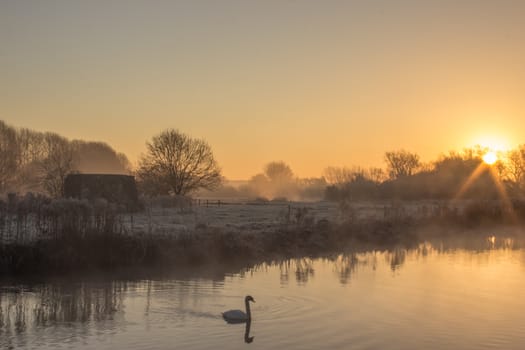 A winter cold frosty Sunrise Over the River Thames at Cheese Wharf, Oxfordshire