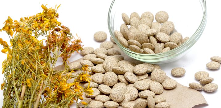 picture of a Perforate St Johns-Wort Flowers and Herbal pills on White Background