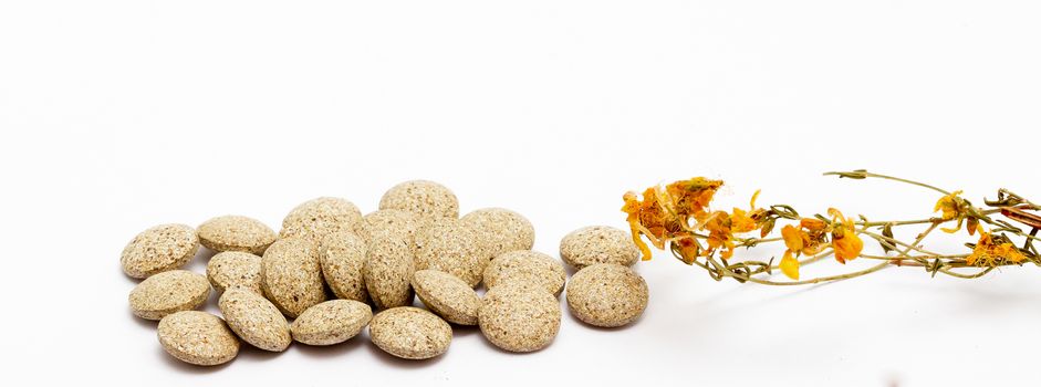 picture of a Perforate St Johns-Wort Flowers and Herbal pills on White Background