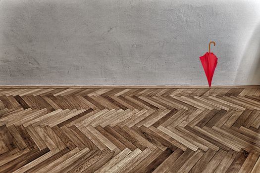 red umbrella on parquet floor and grunge wall