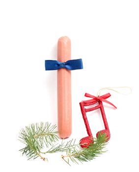 picture of a sausage with bow tie ,music notes , pine twig, funny ,new year greeting card,.Xmas decoration