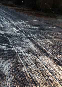 pixture of a repairing asphalt on old road on sunset