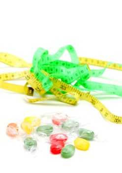 picture of a the colored fruit taste candies. and tape measure .sweet food concept