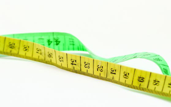 picture of a yellow and green tape measure on white background