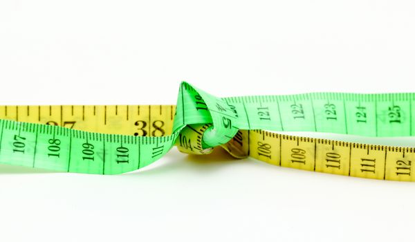picture of a yellow and green tape measure on white background