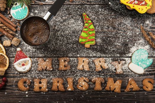 Gingerbreads and coffee for new years and christmas on wooden background, xmas theme