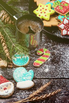 Gingerbreads and coffee for new years and christmas on wooden background, xmas theme