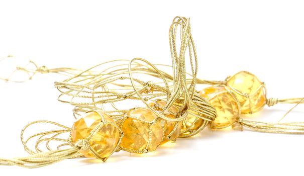 picture of a necklace with cheap plastic gems with golden colored rope