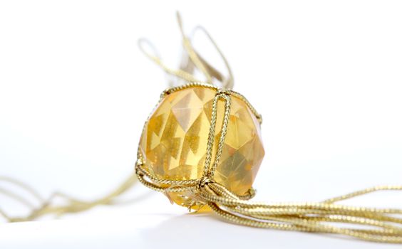 picture of a necklace with cheap plastic gems with golden colored rope