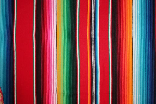 Mexico traditional cinco de mayo rug poncho fiesta background with stripes copy space