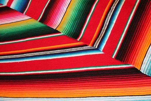 Mexico traditional cinco de mayo rug poncho fiesta background with stripes copy space