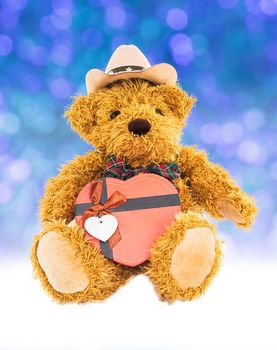 Teddy bear with gifts and ornaments christmas and new year on blue bokeh background