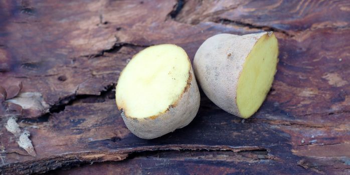 picture of a Sliced potatoes on dark wood background