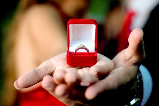 Engagement ring on womans hand held by her friend , picture of a