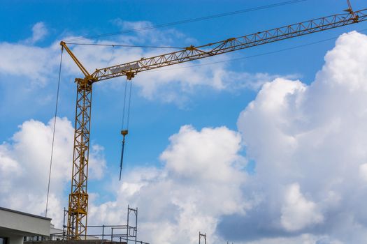 Construction crane against blue sky photographed, space for labeling.
