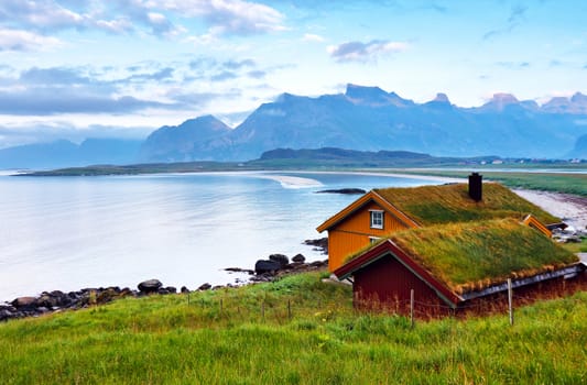 Norway island in fjord. Cloudy Nordic day. Hote, rorbul on lofoten island