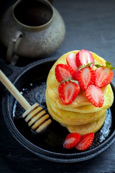 Stack of sweet pancakes with strawberry and honey. Gluten free flour.