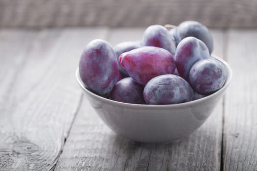 Bunch of Plums on a wooden table.