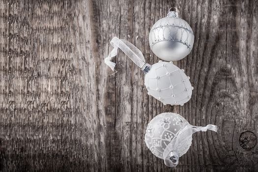 White christmas balls on a wooden background. 