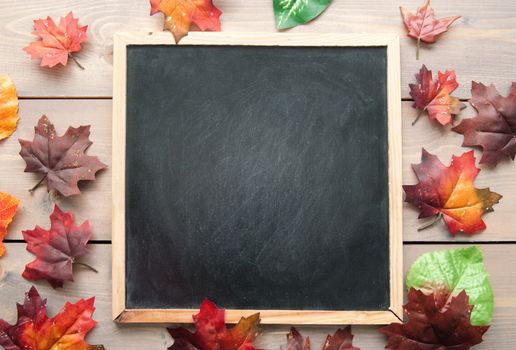 Autumn leaves around a blackboard with space 