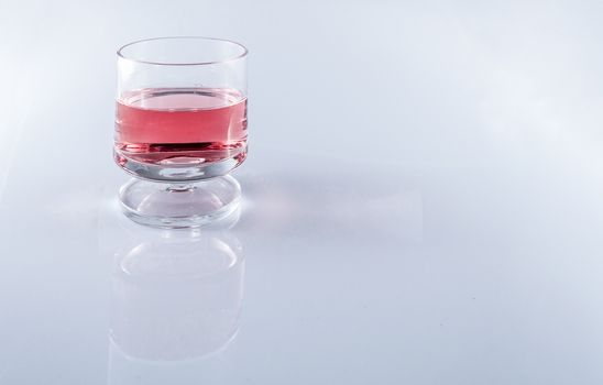 Isolated rosè wine in stemmed glasses on white background with copy space