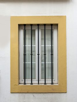 window with bars for security yellow and white