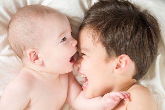 Young Mixed Race Chinese and Caucasian Baby Brothers Having Fun on Their Blanket.