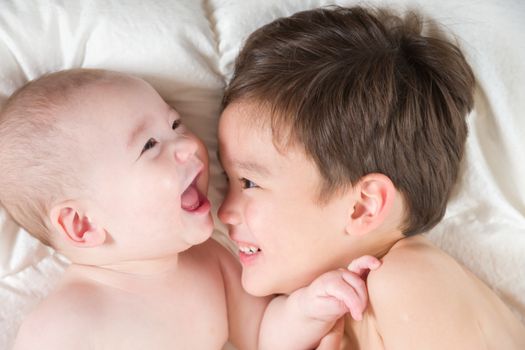 Young Mixed Race Chinese and Caucasian Baby Brothers Having Fun on Their Blanket.