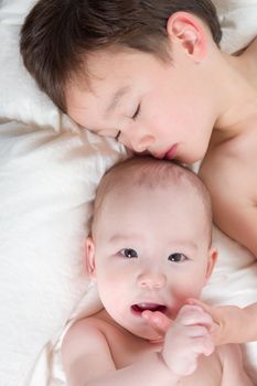 Young Mixed Race Chinese and Caucasian Baby Brothers Having Fun on Their Blanket.