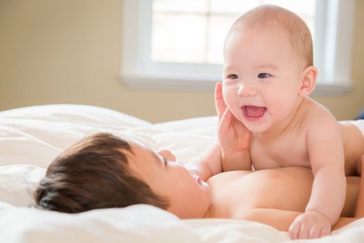 Young Mixed Race Chinese and Caucasian Baby Brothers Having Fun on Their Blanket.