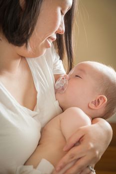 Mixed Race Chinese and Caucasian Baby Boy Being Held By His Mother.